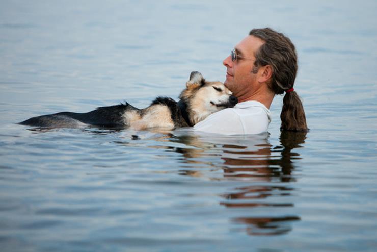 Man relaxes with his pet dog